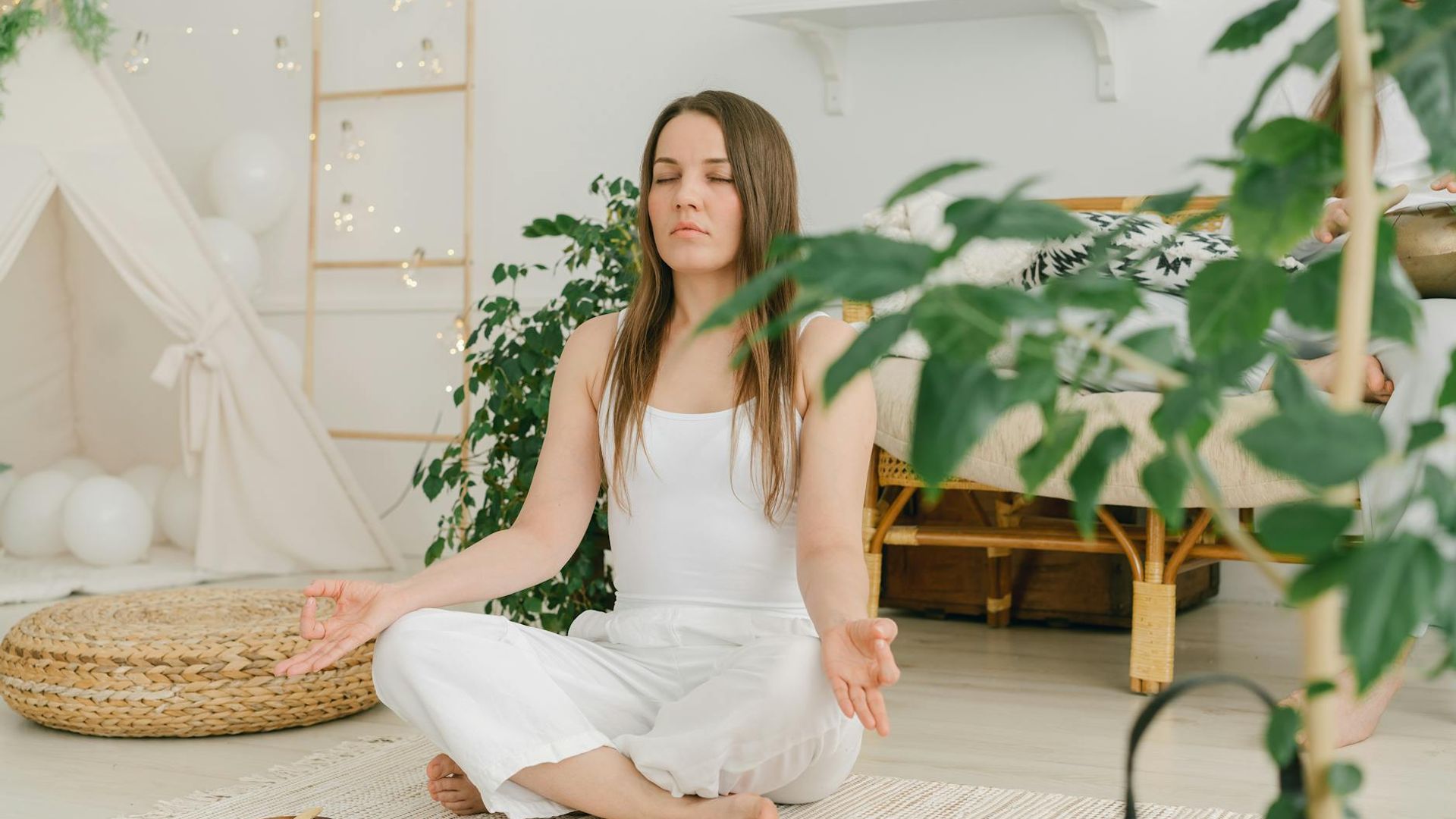 Calm person practicing yoga in a serene, minimalist environment.
